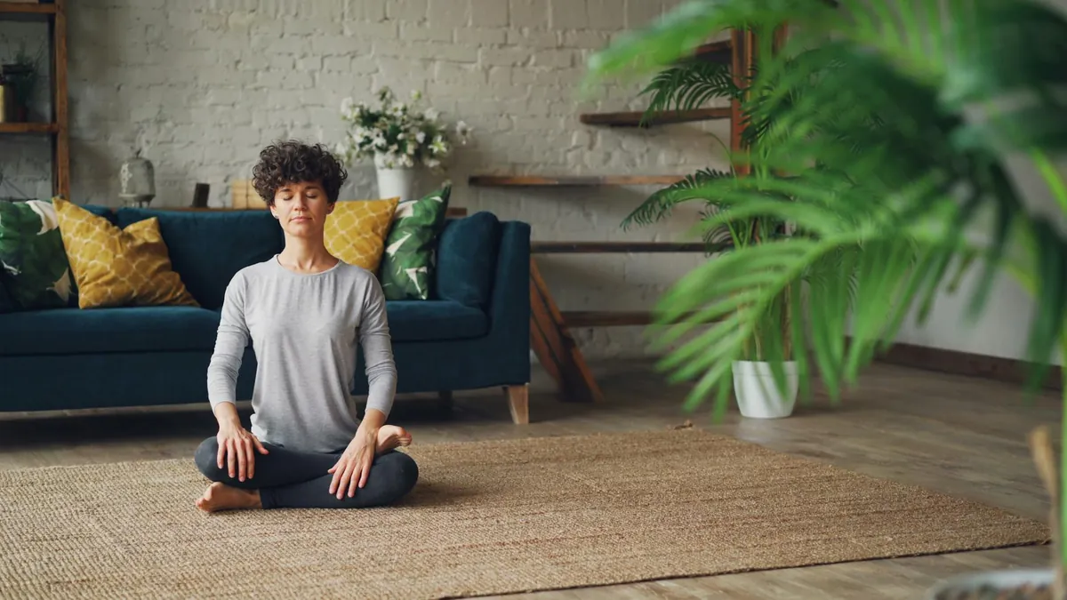 A person sitting peacefully with eyes closed, practicing meditation.