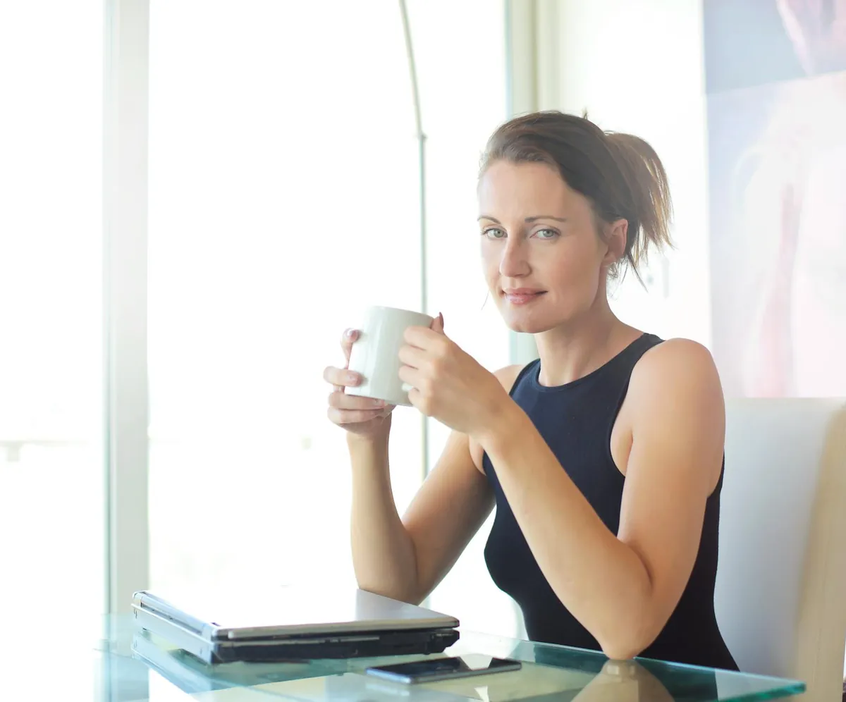 Woman looking overwhelmed at her desk, then smiling while taking a break with a cup of tea.
