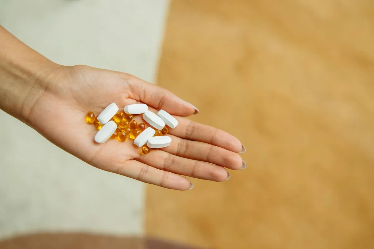 Older adult looking thoughtfully at shelves of vitamins and supplements, representing the choice between essential and unnecessary options for seniors.