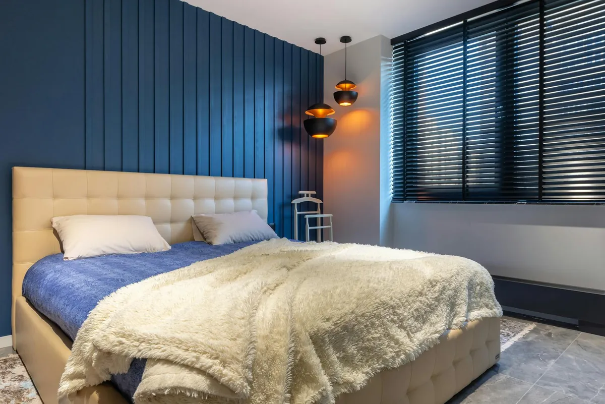 A busy professional looking refreshed and energized after a night of deep sleep, with a calm bedroom environment in the background.