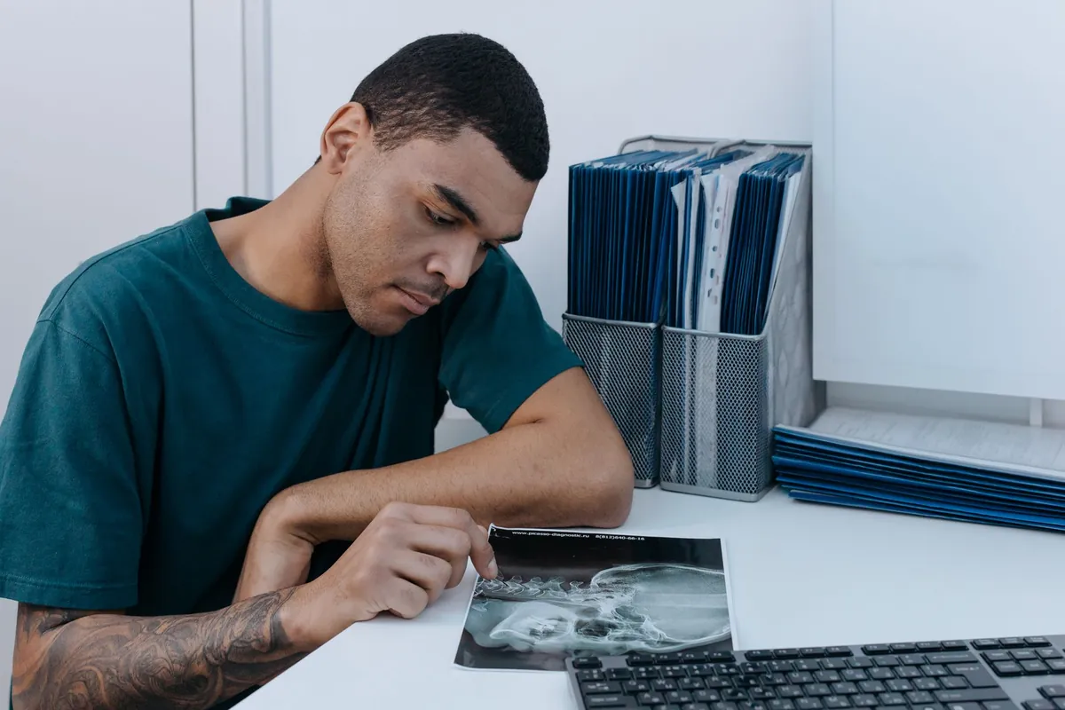 A young, healthy-looking person looking thoughtfully at an abstract representation of lungs, symbolizing the mystery of lung cancer in non-smokers.