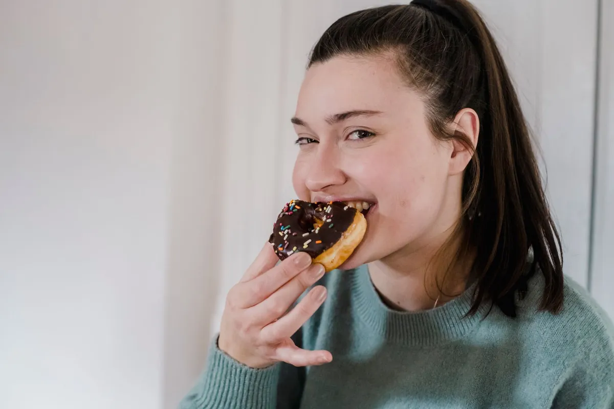 Woman looking thoughtfully at healthy snacks instead of sweets
