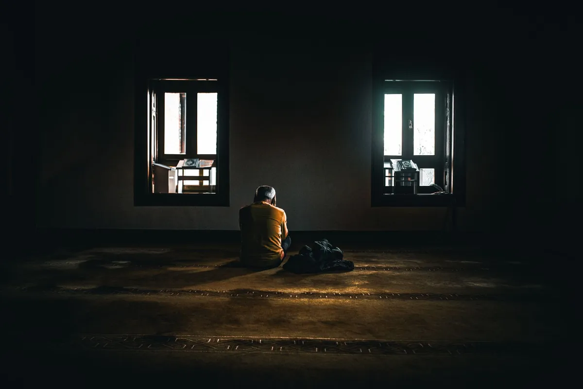 Woman peacefully sleeping in a cool, dark bedroom, symbolizing deep, restorative rest achieved through biohacking techniques.