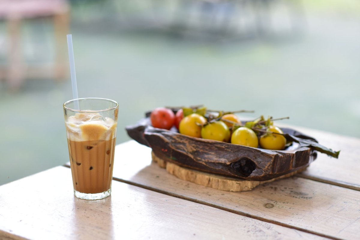 A cup of coffee next to fresh berries illustrating natural alternatives to sugar substitutes.