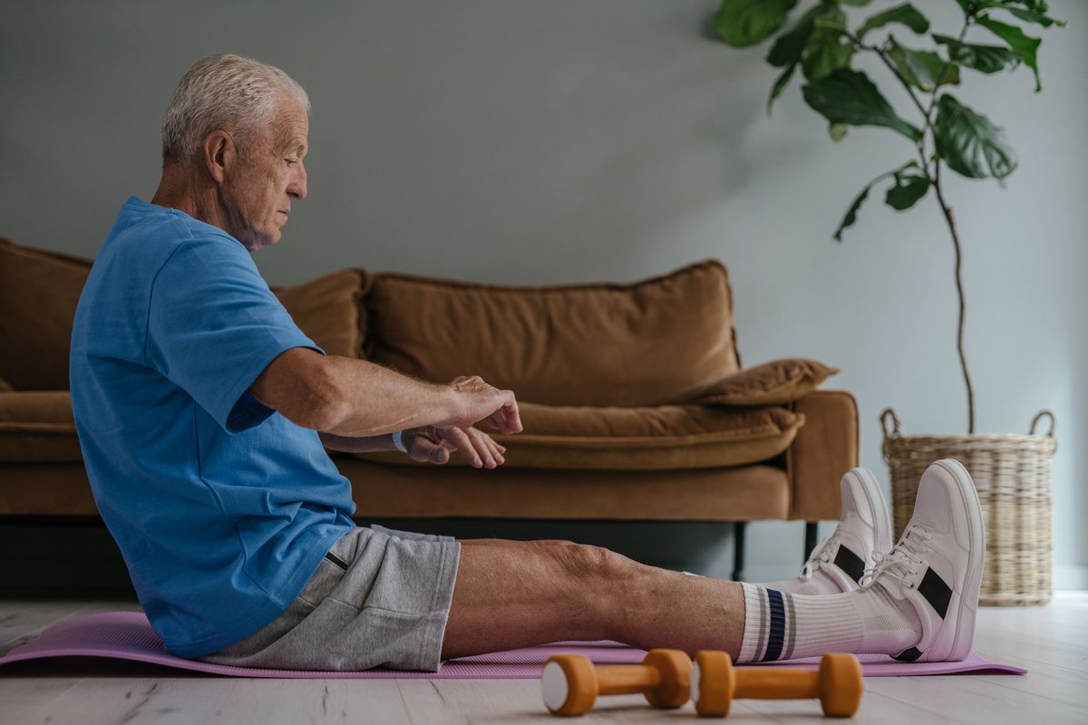 A smiling older adult exercising comfortably at home to support brain health and longevity