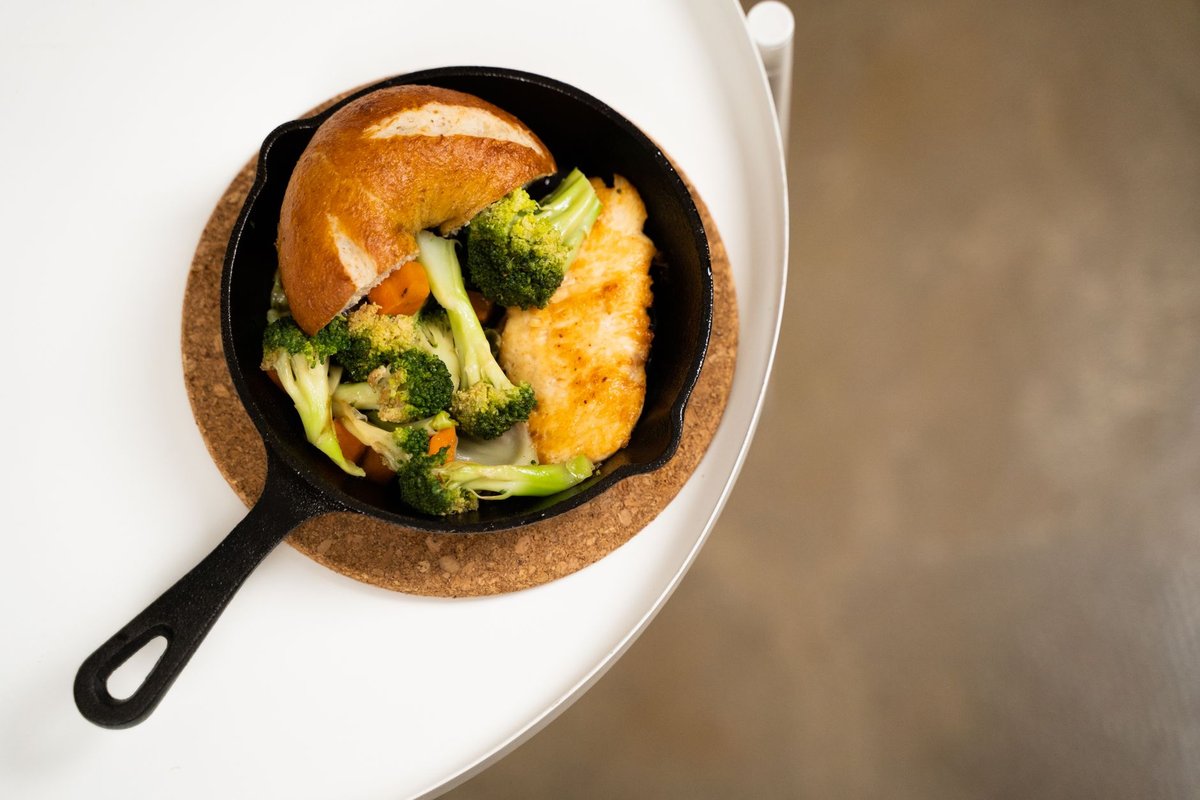 A colorful nutrient dense vegetable and protein skillet meal cooking quickly on a modern kitchen stovetop