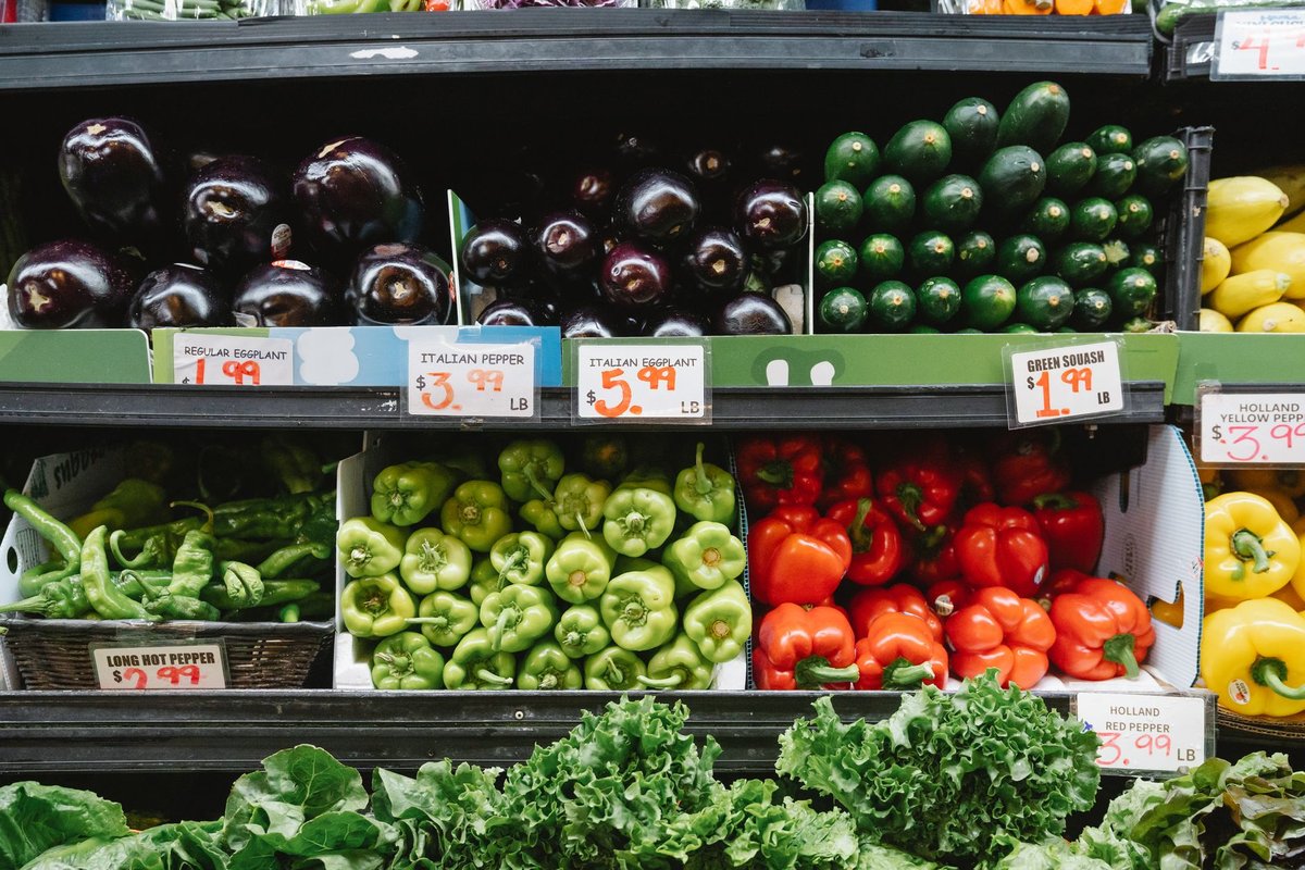 A customer shopping for fresh nutritious produce in a bright grocery store produce section